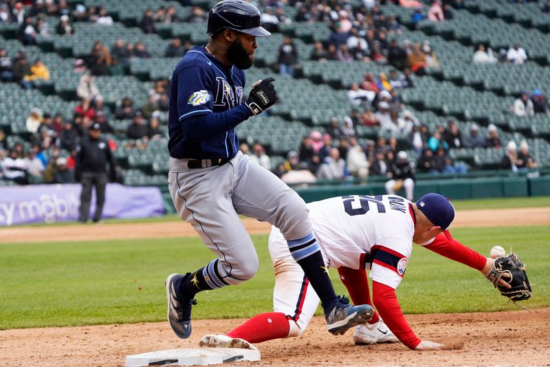 Apr 30, 2023; Chicago, Illinois, USA; Tampa Bay Rays center fielder Manuel Margot (13) beats out the throw for a single as Chicago White Sox first baseman Andrew Vaughn (25) takes the throw during the fourth inning at Guaranteed Rate Field. Mandatory Credit: David Banks-USA TODAY Sports