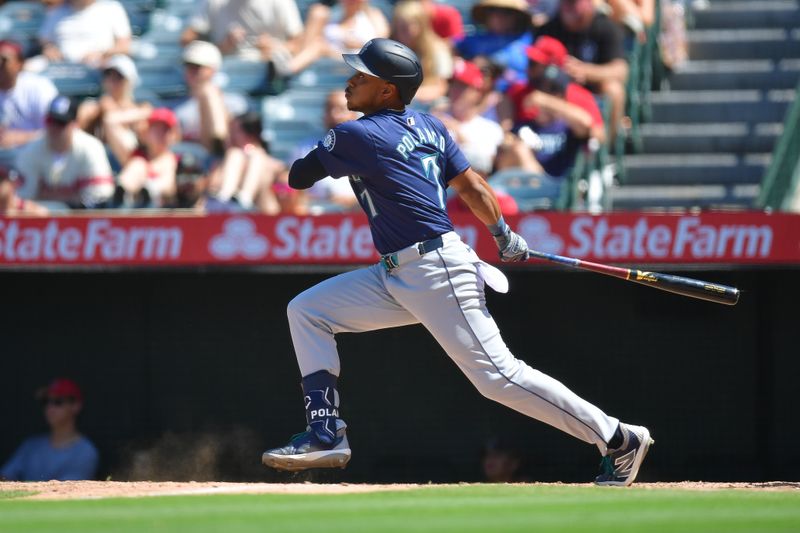 Jul 14, 2024; Anaheim, California, USA; Seattle Mariners second baseman Jorge Polanco (7) hits a single against the Los Angeles Angels during the eighth inning at Angel Stadium. Mandatory Credit: Gary A. Vasquez-USA TODAY Sports