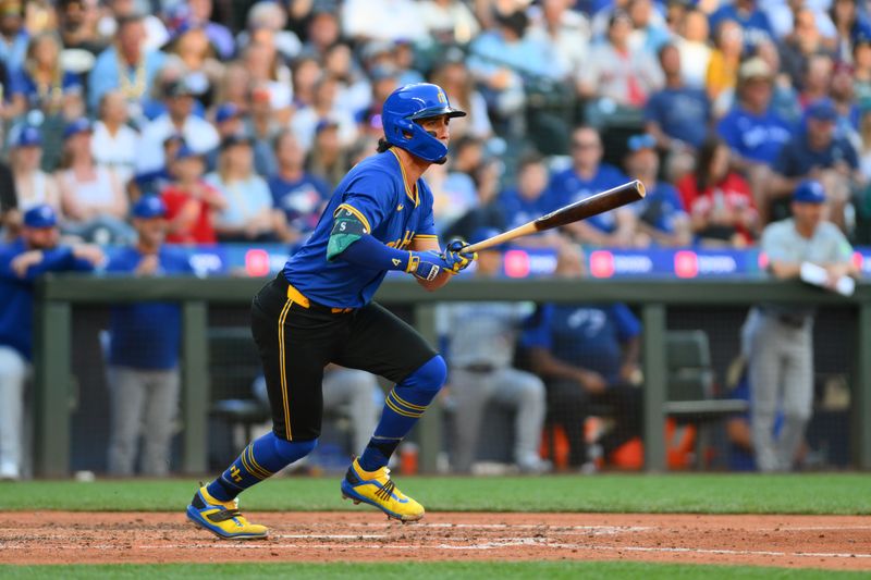 Jul 5, 2024; Seattle, Washington, USA; Seattle Mariners third baseman Josh Rojas (4) hits a double against the Toronto Blue Jays during the fourth inning at T-Mobile Park. Mandatory Credit: Steven Bisig-USA TODAY Sports