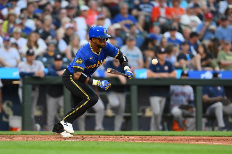 Jul 19, 2024; Seattle, Washington, USA; Seattle Mariners right fielder Victor Robles (10) bunts the ball against the Houston Astros during the fifth inning at T-Mobile Park. Mandatory Credit: Steven Bisig-USA TODAY Sports