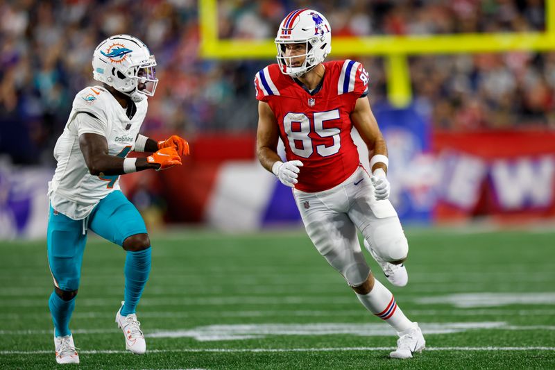 New England Patriots tight end Hunter Henry (85) runs a route against Miami Dolphins cornerback Kader Kohou (4) during the second half of an NFL football game on Sunday, Sept. 17, 2023, in Foxborough, Mass. (AP Photo/Greg M. Cooper)