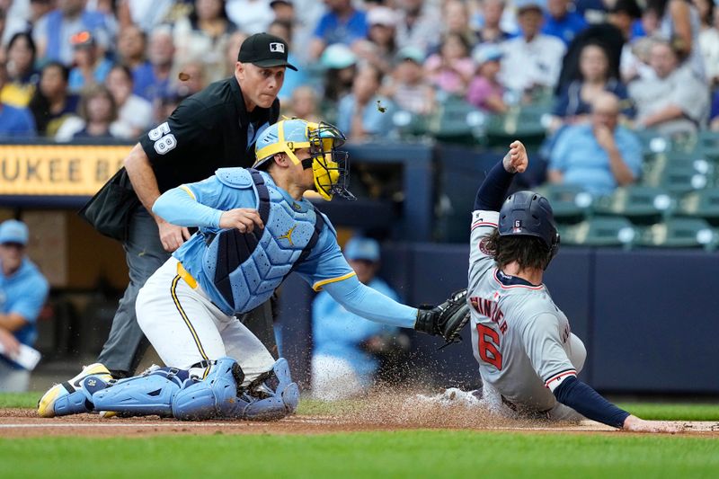 Jul 12, 2024; Milwaukee, Wisconsin, USA;  Milwaukee Brewers catcher William Contreras (24) tags out Washington Nationals designated hitter Jesse Winker (6) on a play at the plate during the first inning at American Family Field. Mandatory Credit: Jeff Hanisch-USA TODAY Sports