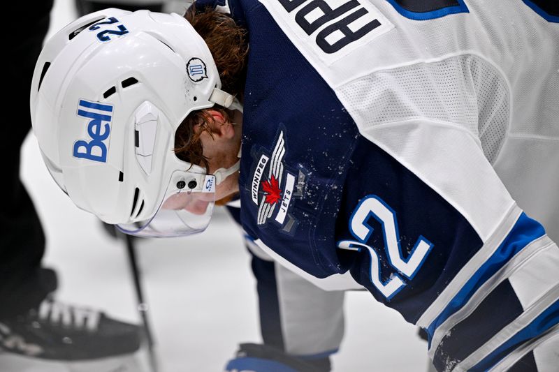 May 11, 2025; Dallas, Texas, USA; Winnipeg Jets center Mason Appleton (22) grabs his head after being hit by a puck during the first period against the Dallas Stars in game three of the second round of the 2025 Stanley Cup Playoffs at American Airlines Center. Mandatory Credit: Jerome Miron-Imagn Images