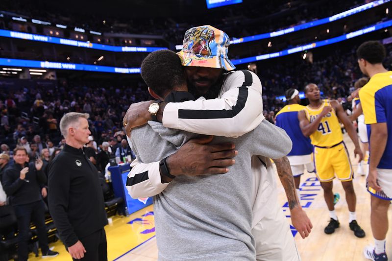 SAN FRANCISCO, CA - OCTOBER 18: Stephen Curry #30 of the Golden State Warriors and LeBron James #23 of the Los Angeles Lakers embrace after the game during a NBA Preseason game on October 18, 2024 at Chase Center in San Francisco, California. NOTE TO USER: User expressly acknowledges and agrees that, by downloading and or using this photograph, user is consenting to the terms and conditions of Getty Images License Agreement. Mandatory Copyright Notice: Copyright 2024 NBAE (Photo by Noah Graham/NBAE via Getty Images)