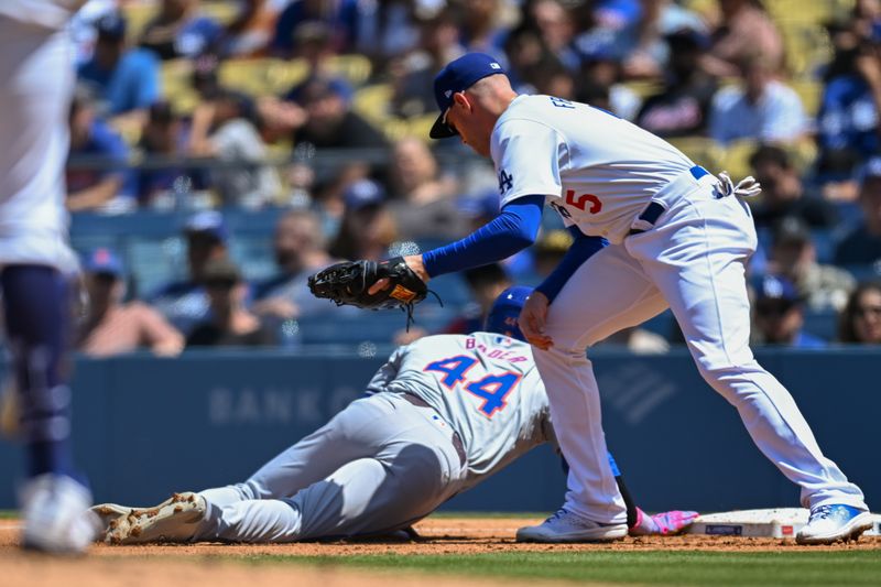 Apr 21, 2024; Los Angeles, California, USA; Los Angeles Dodgers first baseman Freddie Freeman (5) at first base against New York Mets outfielder Harrison Bader (44) during the third inning at Dodger Stadium. Mandatory Credit: Jonathan Hui-USA TODAY Sports