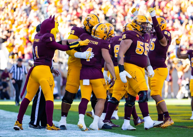 Nov 25, 2023; Tempe, Arizona, USA; Arizona State Sun Devils running back Cameron Skattebo (4) celebrates a touchdown with teammates against the Arizona Wildcats in the first half of the Territorial Cup at Mountain America Stadium. Mandatory Credit: Mark J. Rebilas-USA TODAY Sports