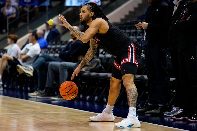 Feb 7, 2026; Provo, Utah, USA;  Houston Cougars forward Joseph Tugler (11) warms prior to a game against the BYU Cougars at Marriott Center. Mandatory Credit: Aaron Baker-Imagn Images