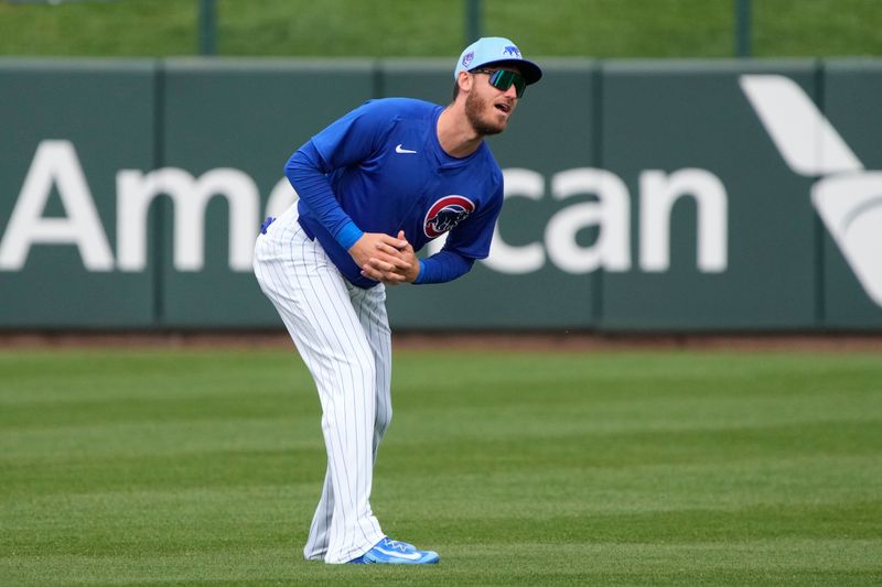 Mar 6, 2024; Mesa, Arizona, USA; Chicago Cubs center fielder Cody Bellinger (24) warms up before a game against the Los Angeles Angels at Sloan Park. Mandatory Credit: Rick Scuteri-USA TODAY Sports