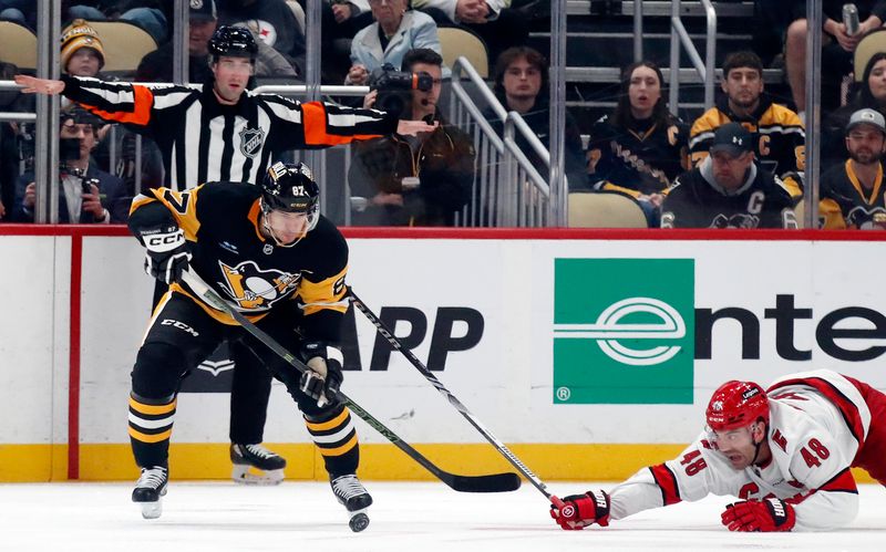 Oct 18, 2024; Pittsburgh, Pennsylvania, USA;  Pittsburgh Penguins center Sidney Crosby (87) heads up ice after stripping the puck off of Carolina Hurricanes left wing Jordan Martinook (48) during the third period at PPG Paints Arena. Mandatory Credit: Charles LeClaire-Imagn Images