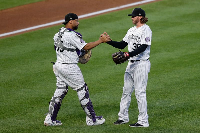 Jun 30, 2023; Denver, Colorado, USA; Colorado Rockies catcher Elias Diaz (35) celebrates with relief pitcher Pierce Johnson (36) after the game against the Detroit Tigers at Coors Field. Mandatory Credit: Isaiah J. Downing-USA TODAY Sports
