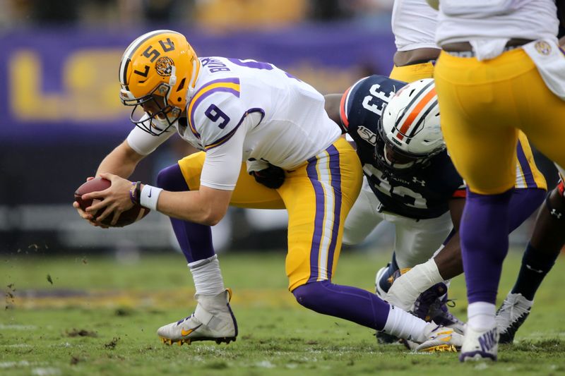 Oct 26, 2019; Baton Rouge, LA, USA; LSU Tigers quarterback Joe Burrow (9) is sacked by Auburn Tigers linebacker K.J. Britt (33) in the first quarter at Tiger Stadium. Mandatory Credit: Chuck Cook-USA TODAY Sports