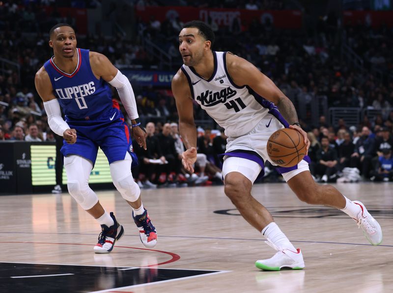 LOS ANGELES, CALIFORNIA - DECEMBER 12: Trey Lyles #41 of the Sacramento Kings dribbles past Russell Westbrook #0 of the LA Clippers during a 119-99 Clippers win at Crypto.com Arena on December 12, 2023 in Los Angeles, California.  NOTE TO USER: User expressly acknowledges and agrees that, by downloading and or using this photograph, User is consenting to the terms and conditions of the Getty Images License Agreement. (Photo by Harry How/Getty Images)