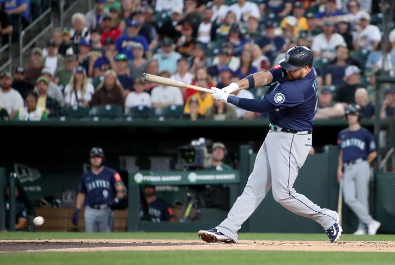 May 5, 2025; West Sacramento, California, USA; Seattle Mariners first baseman Rowdy Tellez (23) hits a RBI double against the Athletics in the third inning at Sutter Health Park. Mandatory Credit: Dennis Lee-Imagn Images
