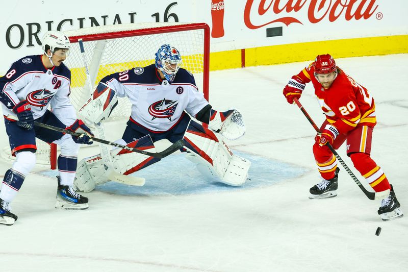 Dec 3, 2024; Calgary, Alberta, CAN; Columbus Blue Jackets goaltender Elvis Merzlikins (90) makes a save against the Calgary Flames during the first period at Scotiabank Saddledome. Mandatory Credit: Sergei Belski-Imagn Images