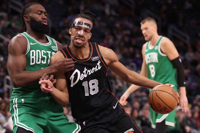 DETROIT, MICHIGAN - MARCH 22: Tosan Evbuomwan #18 of the Detroit Pistons drives to the basket against Jaylen Brown #7 of the Boston Celtics during the second half at Little Caesars Arena on March 22, 2024 in Detroit, Michigan. Boston won the game 129-102. NOTE TO USER: User expressly acknowledges and agrees that, by downloading and or using this photograph, User is consenting to the terms and conditions of the Getty Images License. (Photo by Gregory Shamus/Getty Images)