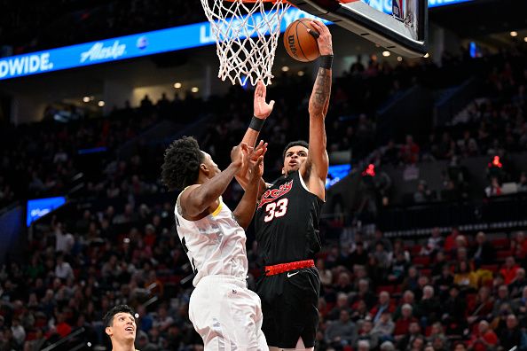 PORTLAND, OREGON - DECEMBER 14: Toumani Camara #33 of the Portland Trail Blazers shoots over Collin Sexton #2 of the Utah Jazz during the third quarter of the game at Moda Center on December 14, 2023 in Portland, Oregon. The Utah Jazz won 122-114. NOTE TO USER: User expressly acknowledges and agrees that, by downloading and or using this Photograph, user is consenting to the terms and conditions of the Getty Images License Agreement. (Photo by Alika Jenner/Getty Images)