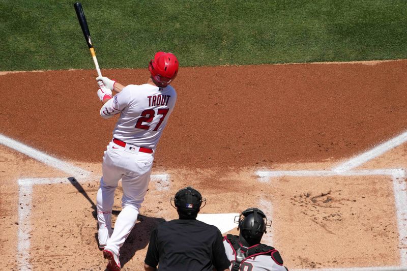 Jul 2, 2023; Anaheim, California, USA; Los Angeles Angels center fielder Mike Trout (27) hits a solo home run in the first inning against the Arizona Diamondbacks at Angel Stadium. Mandatory Credit: Kirby Lee-USA TODAY Sports