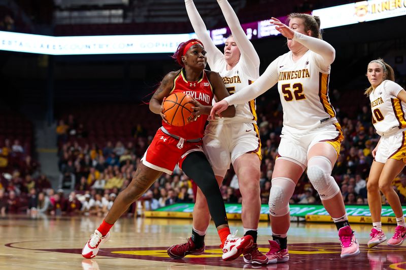 Jan 3, 2024; Minneapolis, Minnesota, USA; Maryland Terrapins guard Bri McDaniel (24) works toward the basket as Minnesota Golden Gophers guard Grace Grocholski (25) defends during the second half at Williams Arena. Mandatory Credit: Matt Krohn-USA TODAY Sports