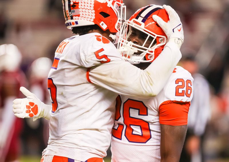 Nov 27, 2021; Columbia, South Carolina, USA; Clemson Tigers running back Phil Mafah (26) celebrates with quarterback D.J. Uiagalelei (5) after scoring a touchdown South Carolina Gamecocks in the fourth quarter at Williams-Brice Stadium. Mandatory Credit: Jeff Blake-USA TODAY Sports