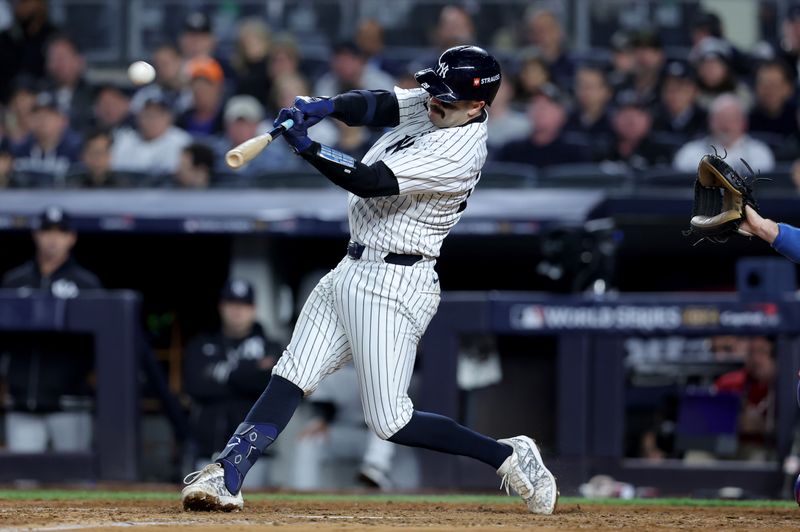 Oct 29, 2024; New York, New York, USA; New York Yankees catcher Austin Wells (28) hits a home run during the sixth inning against the Los Angeles Dodgers in game four of the 2024 MLB World Series at Yankee Stadium. Mandatory Credit: Brad Penner-Imagn Images