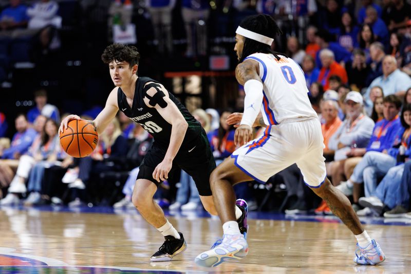 Dec 29, 2025; Gainesville, Florida, USA; Dartmouth Big Green guard Connor Amundsen (30) dribbles the ball while Florida Gators guard Boogie Fland (0) defends during the first half at Exactech Arena at the Stephen C. O'Connell Center. Mandatory Credit: Matt Pendleton-Imagn Images