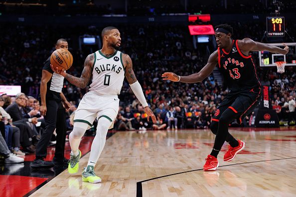 TORONTO, CANADA - NOVEMBER 15: Damian Lillard #0 of the Milwaukee Bucks looks to make a pass as Pascal Siakam #43 of the Toronto Raptors defends during the second half of their NBA game against the Toronto Raptors at Scotiabank Arena on November 15, 2023 in Toronto, Canada. NOTE TO USER: User expressly acknowledges and agrees that, by downloading and or using this photograph, User is consenting to the terms and conditions of the Getty Images License Agreement. (Photo by Cole Burston/Getty Images)