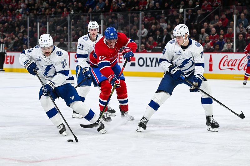 Jan 21, 2025; Montreal, Quebec, CAN; Tampa Bay Lightning center Michael Eyssimont (23) defends the puck agianst Montreal Canadiens right wing Patrik Laine (92) during the first period at Bell Centre. Mandatory Credit: David Kirouac-Imagn Images