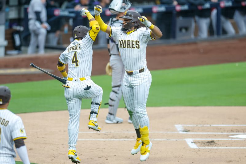 Apr 12, 2025; San Diego, California, USA;  San Diego Padres right fielder Fernando Tatis Jr. (23) celebrates with 
San Diego Padres first baseman Luis Arraez (4) after hitting a one-run home run during the first inning against the Colorado Rockies atat Petco Park. Mandatory Credit: David Frerker-Imagn Images