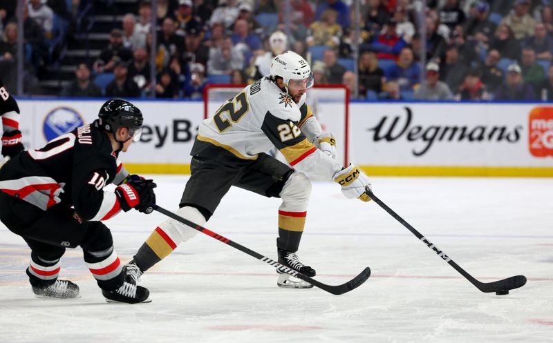 Mar 2, 2024; Buffalo, New York, USA;  Vegas Golden Knights right wing Michael Amadio (22) plays the puck as Buffalo Sabres defenseman Henri Jokiharju (10) defends during the third period at KeyBank Center. Mandatory Credit: Timothy T. Ludwig-USA TODAY Sports