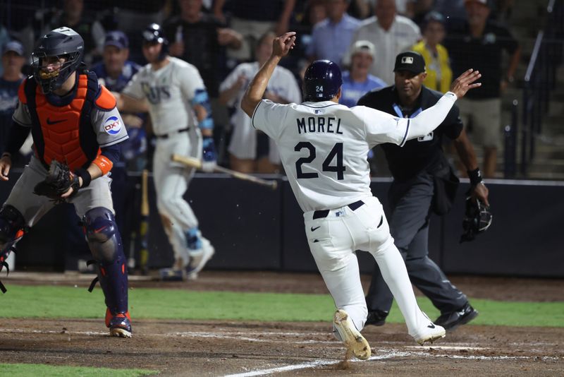 May 20, 2025; St. Petersburg, Florida, USA; Tampa Bay Rays outfielder Christopher Morel (24) slides safe at home after he scored the game winning run during the ninth inning against the Houston Astros at George M. Steinbrenner Field. Mandatory Credit: Kim Klement Neitzel-Imagn Images