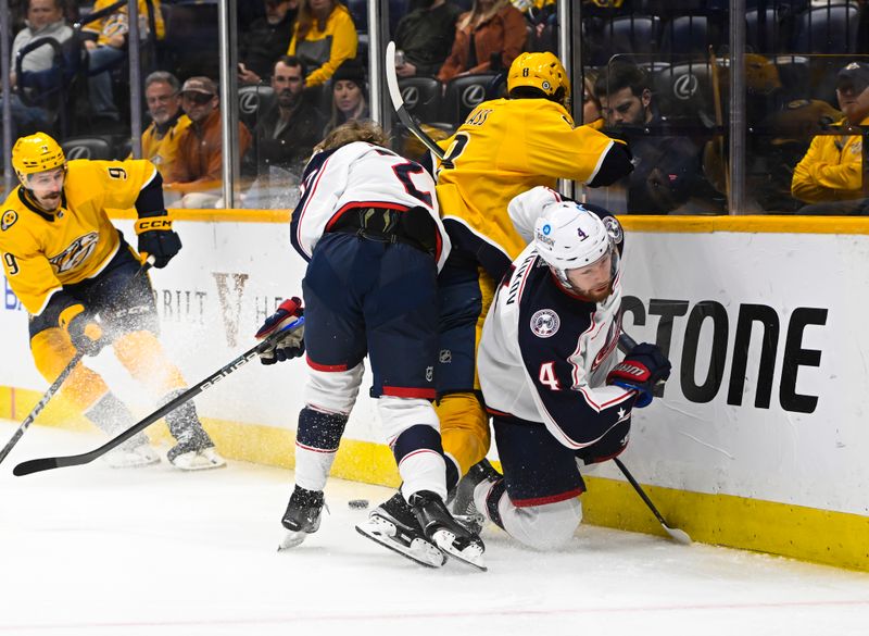 Jan 17, 2023; Nashville, Tennessee, USA;  Columbus Blue Jackets defenseman Vladislav Gavrikov (4) and Columbus Blue Jackets defenseman Adam Boqvist (27) check Nashville Predators center Cody Glass (8) during the first period at Bridgestone Arena. Mandatory Credit: Steve Roberts-USA TODAY Sports