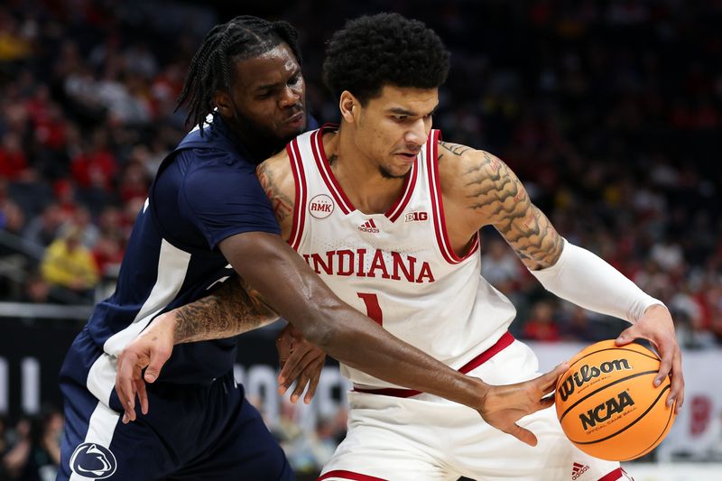 Mar 14, 2024; Minneapolis, MN, USA; Penn State Nittany Lions forward Qudus Wahab (22) strips the ball from Penn State Nittany Lions guard Ace Baldwin Jr. (1) during the first half at Target Center. Mandatory Credit: Matt Krohn-USA TODAY Sports