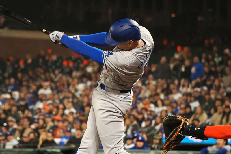 May 14, 2024; San Francisco, California, USA; Los Angeles Dodgers first baseman Freddie Freeman (5) hits a RBI single against the San Francisco Giants during the ninth inning at Oracle Park. Mandatory Credit: Kelley L Cox-USA TODAY Sports