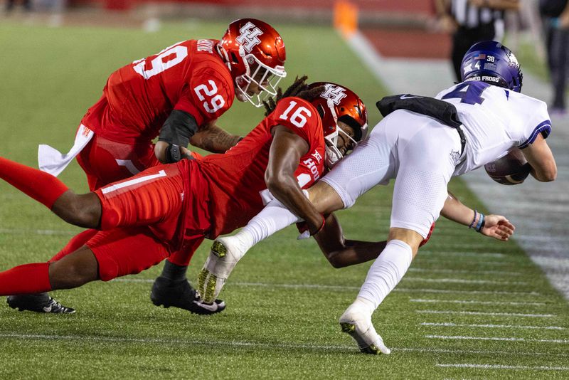 Sep 16, 2023; Houston, Texas, USA;TCU Horned Frogs quarterback Chandler Morris (4) dives for a first down against Houston Cougars linebacker Treylin Payne (29) and  defensive back Brian George (16) in the first half at TDECU Stadium. Mandatory Credit: Thomas Shea-USA TODAY Sports