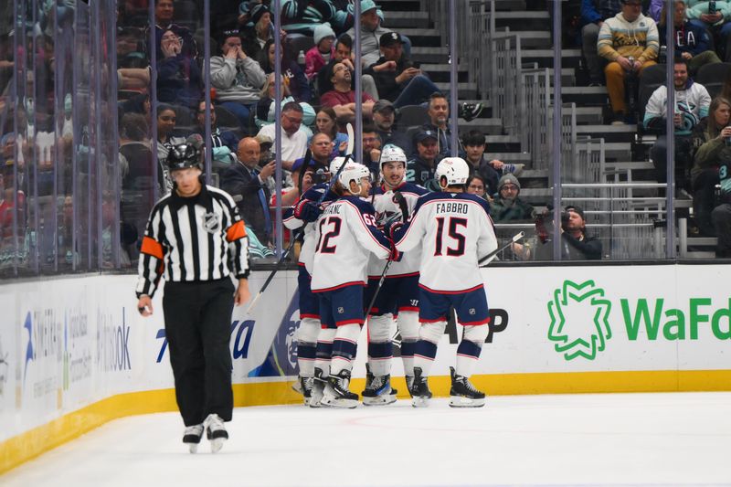 Nov 12, 2024; Seattle, Washington, USA; The Columbus Blue Jackets celebrate after a goal scored by center Zachary Aston-Reese (27) against the Seattle Kraken during the first period at Climate Pledge Arena. Mandatory Credit: Steven Bisig-Imagn Images