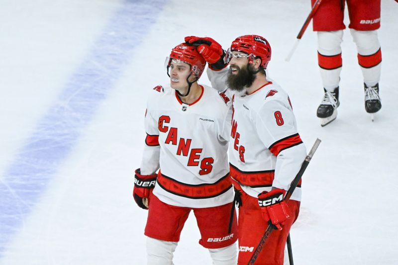 Jan 20, 2025; Chicago, Illinois, USA;  Carolina Hurricanes center Sebastian Aho (20) celebrates with  defenseman Brent Burns (8) after he scores the game winning goal during the overtime period against the Chicago Blackhawks at the United Center. Mandatory Credit: Matt Marton-Imagn Images


