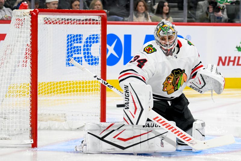 Nov 29, 2024; Saint Paul, Minnesota, USA;  Chicago Blackhawks goalie Petr Mrazek (34) makes a blocker save against the Minnesota Wild during the second period at Xcel Energy Center. Mandatory Credit: Nick Wosika-Imagn Images