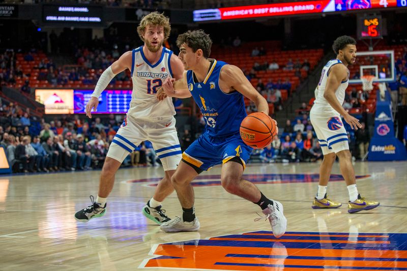 Jan 3, 2023; Boise, Idaho, USA; Boise State Broncos guard Max Rice (12) guards San Jose State Spartans guard Alvaro Cardenas (13) during the first half at ExtraMile Arena. Mandatory Credit: Brian Losness-USA TODAY Sports

