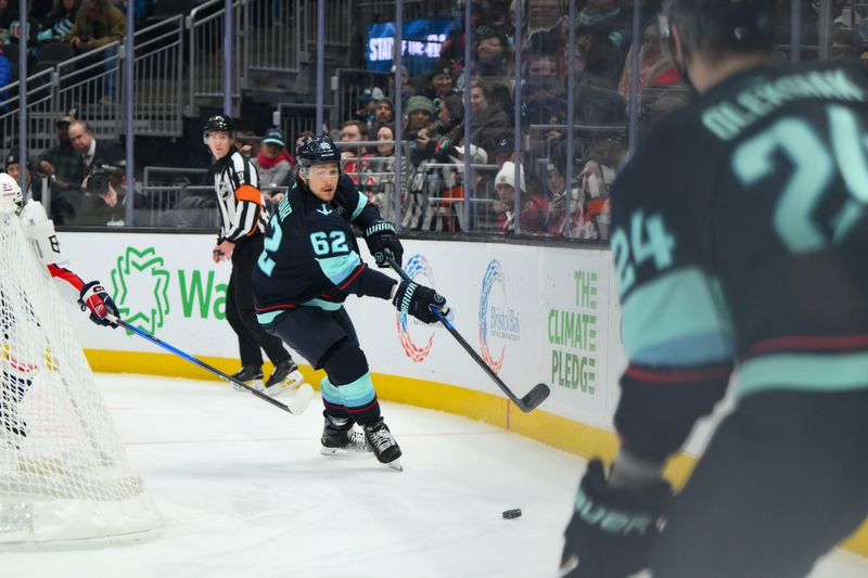 Jan 27, 2026; Seattle, Washington, USA; Seattle Kraken defenseman Brandon Montour (62) passes the puck to defenseman Jamie Oleksiak (24) during the first period against the Washington Capitals at Climate Pledge Arena. Mandatory Credit: Steven Bisig-Imagn Images