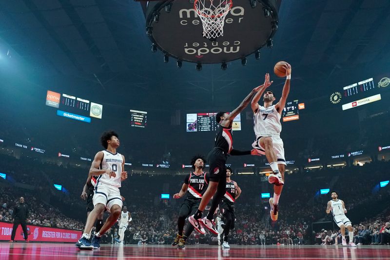 PORTLAND, OREGON - NOVEMBER 10: Santi Aldama #7 of the Memphis Grizzlies drives to the basket against Anfernee Simons #1 of the Portland Trail Blazers during the second half at Moda Center on November 10, 2024 in Portland, Oregon. NOTE TO USER: User expressly acknowledges and agrees that, by downloading and or using this photograph, User is consenting to the terms and conditions of the Getty Images License Agreement. (Photo by Soobum Im/Getty Images)