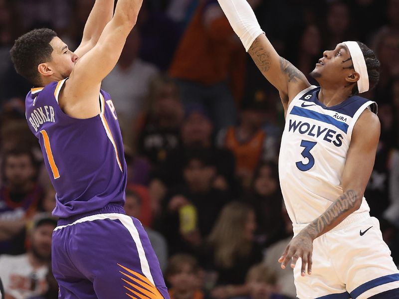 PHOENIX, ARIZONA - MARCH 29: Devin Booker #1 of the Phoenix Suns attempts a shot over Jaden McDaniels #3 of the Minnesota Timberwolves during the first half of the NBA game at Footprint Center on March 29, 2023 in Phoenix, Arizona. The Suns defeated the Timberwolves 107-100. NOTE TO USER: User expressly acknowledges and agrees that, by downloading and or using this photograph, User is consenting to the terms and conditions of the Getty Images License Agreement.  (Photo by Christian Petersen/Getty Images)