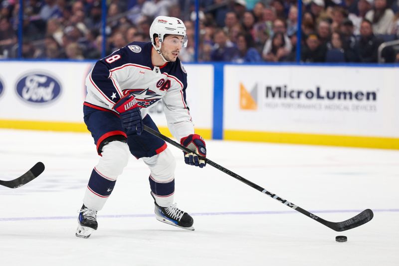 Mar 4, 2025; Tampa, Florida, USA; Columbus Blue Jackets defenseman Zach Werenski (8) controls the puck against the Tampa Bay Lightning in the first period at Amalie Arena. Mandatory Credit: Nathan Ray Seebeck-Imagn Images