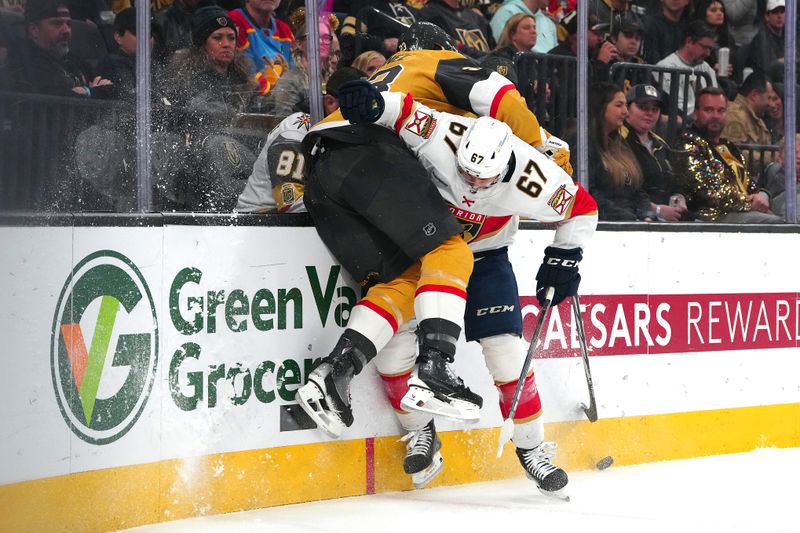 Jan 4, 2024; Las Vegas, Nevada, USA; Vegas Golden Knights defenseman Alec Martinez (23) is checked by Florida Panthers right wing William Lockwood (67) during the first period at T-Mobile Arena. Mandatory Credit: Stephen R. Sylvanie-USA TODAY Sports