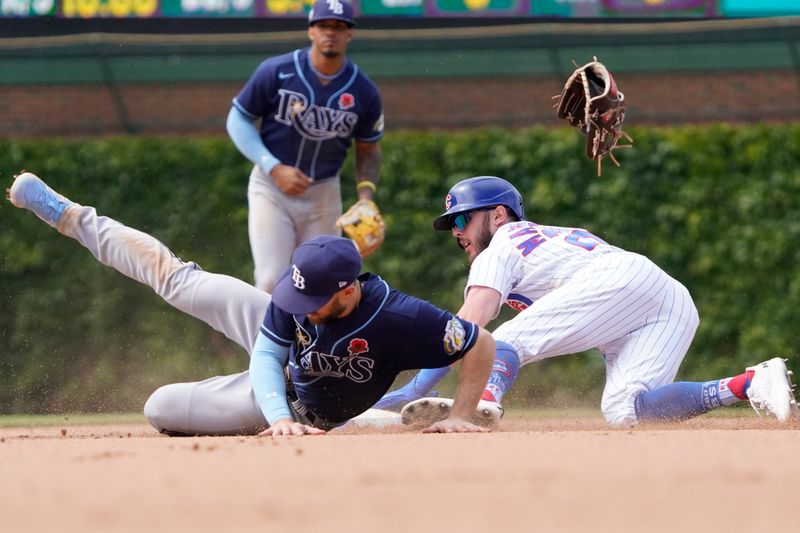 May 29, 2023; Chicago, Illinois, USA; Chicago Cubs third baseman Miles Mastrobuoni (20) steals second base as Tampa Bay Rays second baseman Brandon Lowe (8) loses his glove during the eighth inning at Wrigley Field. Mandatory Credit: David Banks-USA TODAY Sports