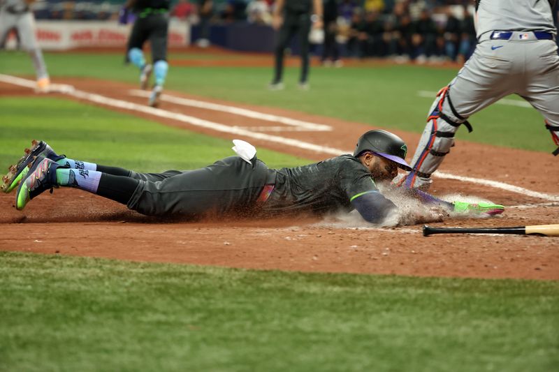 May 4, 2024; St. Petersburg, Florida, USA;  Tampa Bay Rays first base Yandy Daaz (2) is tagged out by New York Mets catcher Tomas Nido (3) at home plate during the eighth inning at Tropicana Field. Mandatory Credit: Kim Klement Neitzel-USA TODAY Sports