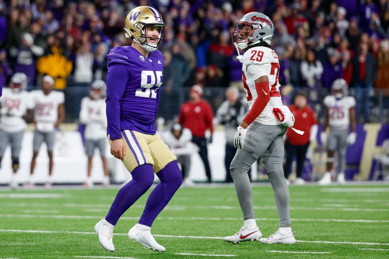 Nov 25, 2023; Seattle, Washington, USA; Washington Huskies place kicker Grady Gross (95) celebrates after kicking a game-winning field goal against the Washington State Cougars during the fourth quarter at Alaska Airlines Field at Husky Stadium. Washington defeated Washington State, 24-21. Washington State Cougars defensive back Jamorri Colson (29) reacts at right. Mandatory Credit: Joe Nicholson-USA TODAY Sports