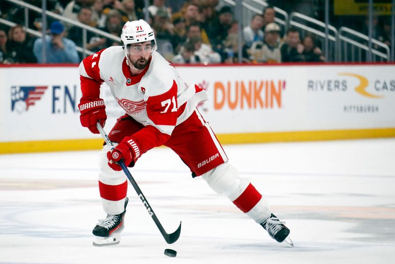 Apr 11, 2024; Pittsburgh, Pennsylvania, USA; Detroit Red Wings center Dylan Larkin (71) skates up ice with the puck against the Pittsburgh Penguins during the second period at PPG Paints Arena. Pittsburgh won 6-5 in overtime. Mandatory Credit: Charles LeClaire-USA TODAY Sports