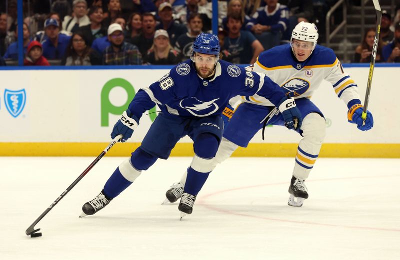 Apr 15, 2024; Tampa, Florida, USA;  Tampa Bay Lightning left wing Brandon Hagel (38) skates with the puck as Buffalo Sabres center Tage Thompson (72) defends during the first period at Amalie Arena. Mandatory Credit: Kim Klement Neitzel-USA TODAY Sports