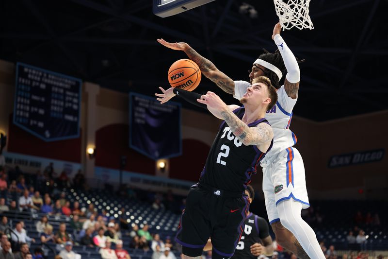 Nov 27, 2025; San Diego, California, USA; Florida Gators guard Boogie Fland (0) blocks Texas Christian University Horned Frogs guard Brock Harding (2) during the first half at Jenny Craig Pavilion. Mandatory Credit: Abe Arredondo-Imagn Images