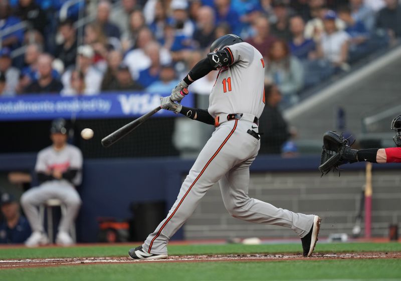 Jun 3, 2024; Toronto, Ontario, CAN; Baltimore Orioles third baseman Jordan Westburg (11) hits a single against the Toronto Blue Jays during the second inning at Rogers Centre. Mandatory Credit: Nick Turchiaro-USA TODAY Sports